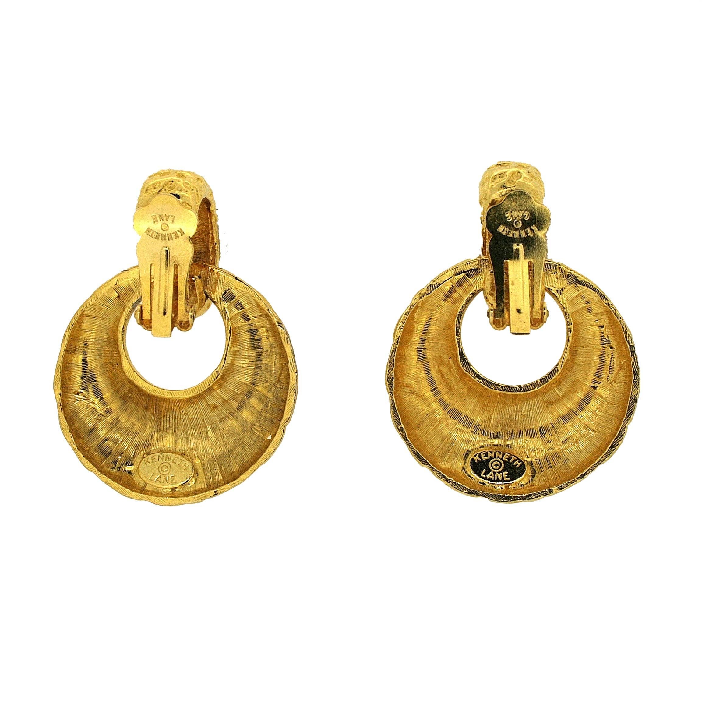 These clip on earrings a bold and bright design. They were made in the 1970s by Kenneth Jay Lane.
Condition Report:
Excellent
The Details...
These earrings feature a 'door knocker' style design, made from hammered gold tone metal. They measure 5cm x