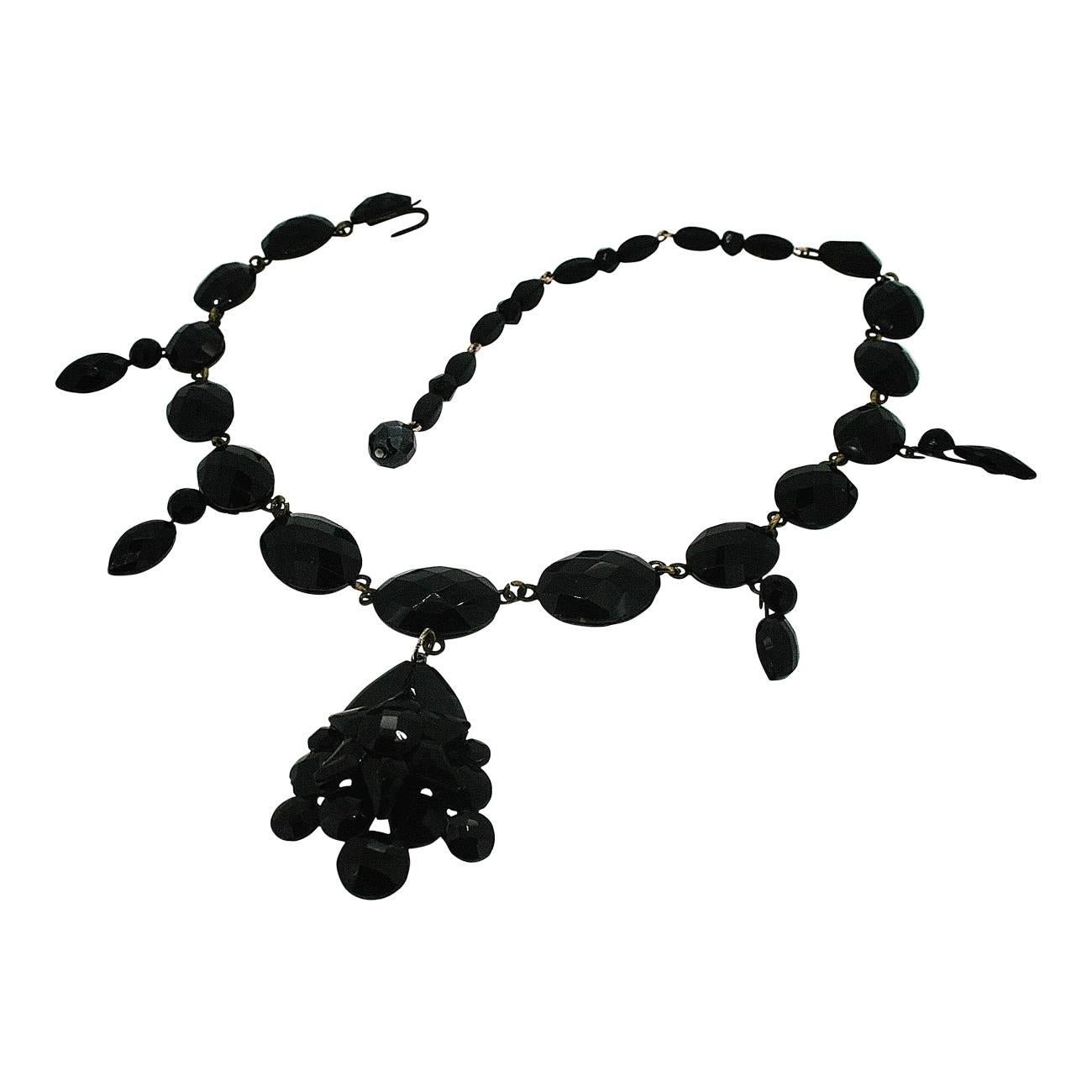 This beautiful multi-faceted black glass necklace is a rare, intricate example of late 1800s French Jet. 
Condition Report:
Excellent
The Details...
This French Jet (black glass) necklace features a strand of oval shaped French Jet cabochons,