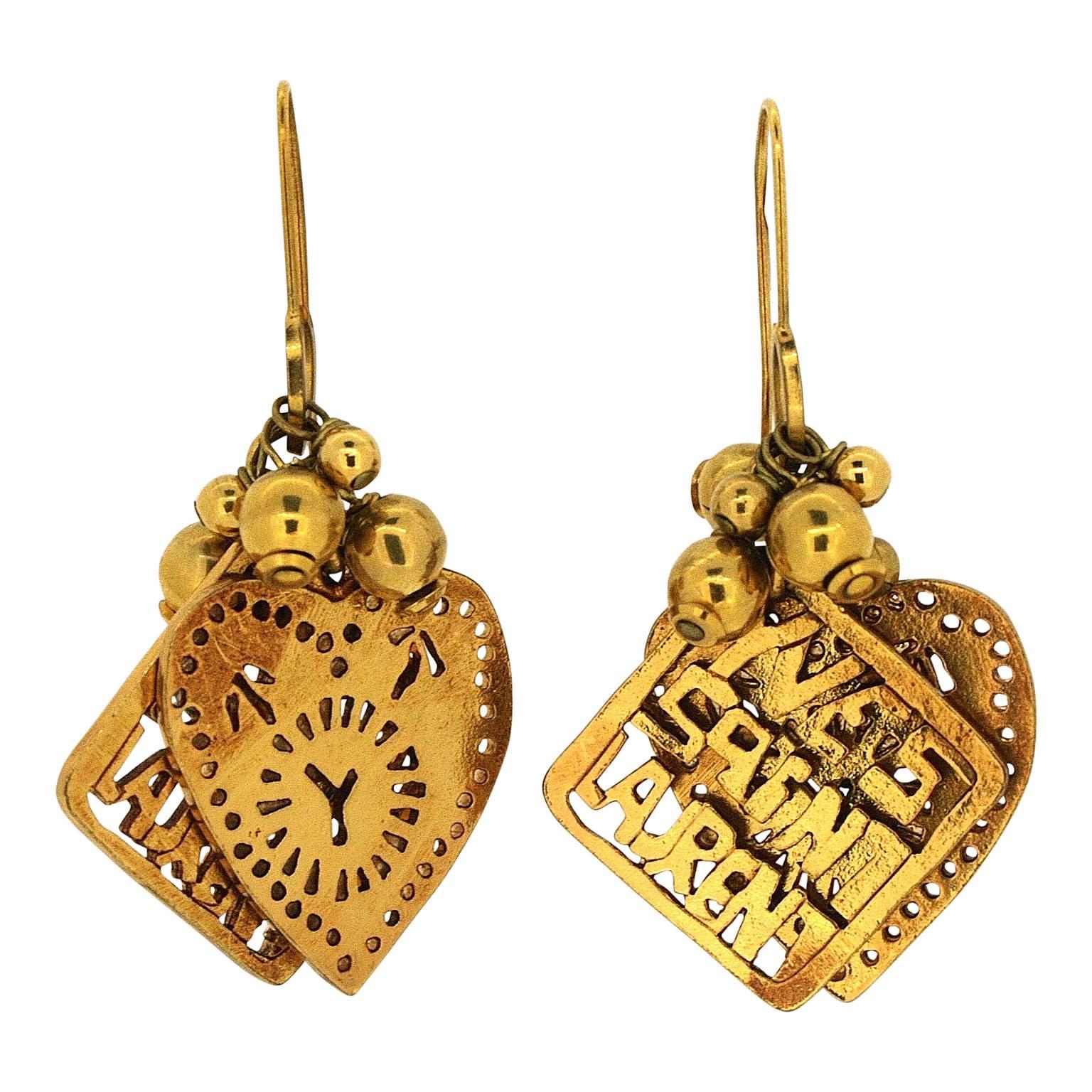 Fun and with delightful details, this earrings and necklace set is by Yves Saint Laurent. It dates from the 1980s. 
Condition Report:
Good - Some ageing to the gold tone metal in places on all pieces. This is consistent with age and use and does not