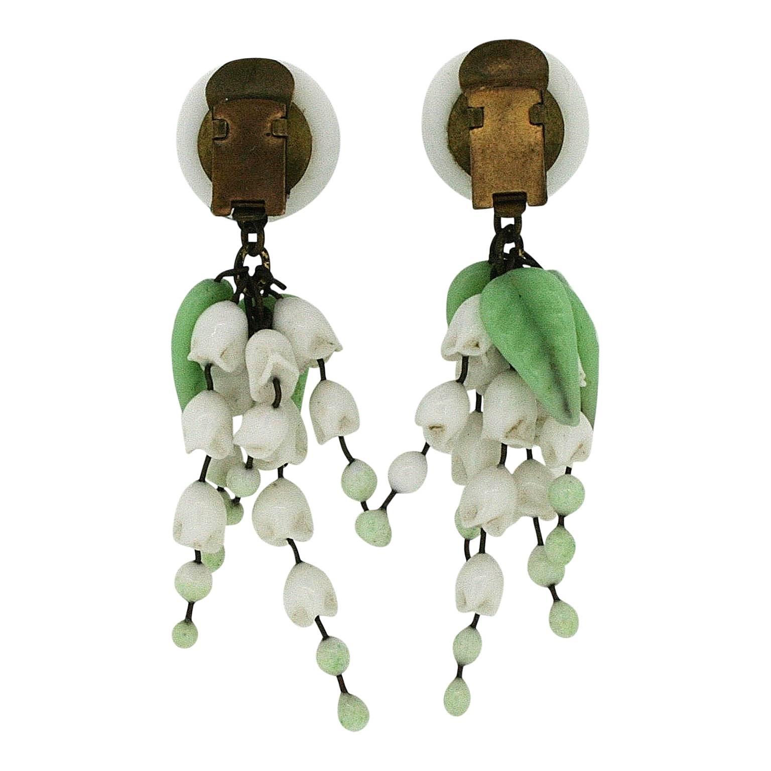 Featuring delicate glass flowers and leaves, these earrings were created in France during the 1940s.
Condition Report:
Very Good - One leaf is missing from one earring and there is some wear to the gilt metal consistent with age and use. This is
