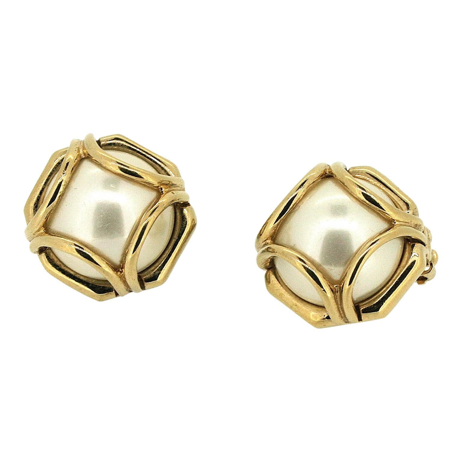 Classic and elegant, these earrings date from the 1980s and were made by Ciner.
Condition Report:
Excellent
The Details...
These earrings feature a faux pearl cabochon set within a gold tone metal cage design. They are clip on. They are signed. The