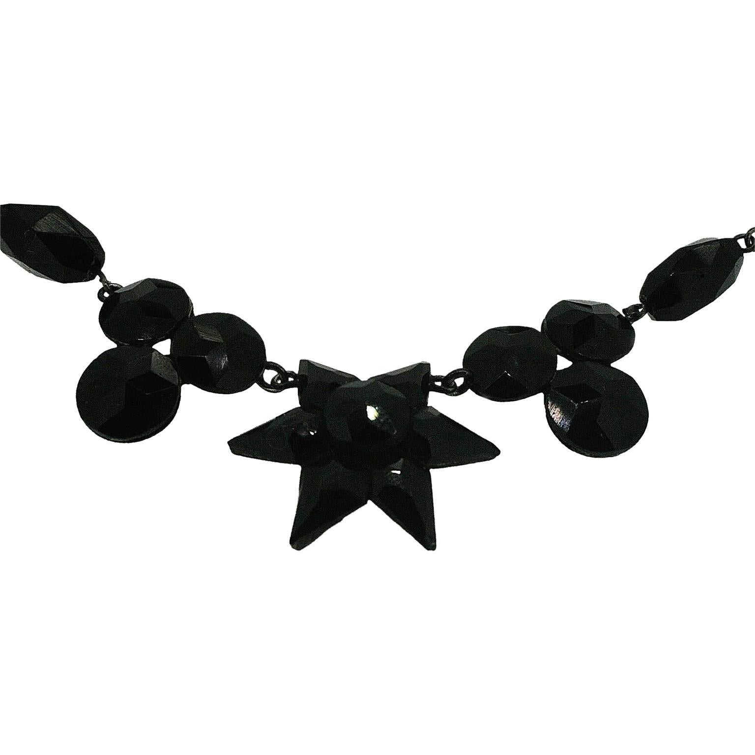 This beautiful multi-faceted black glass necklace features a pretty and interesting star motif. 
Condition Report:
Excellent
The Details...
This French Jet (black glass) necklace features a strand of multi-faceted, lozenge shaped beads. There is a