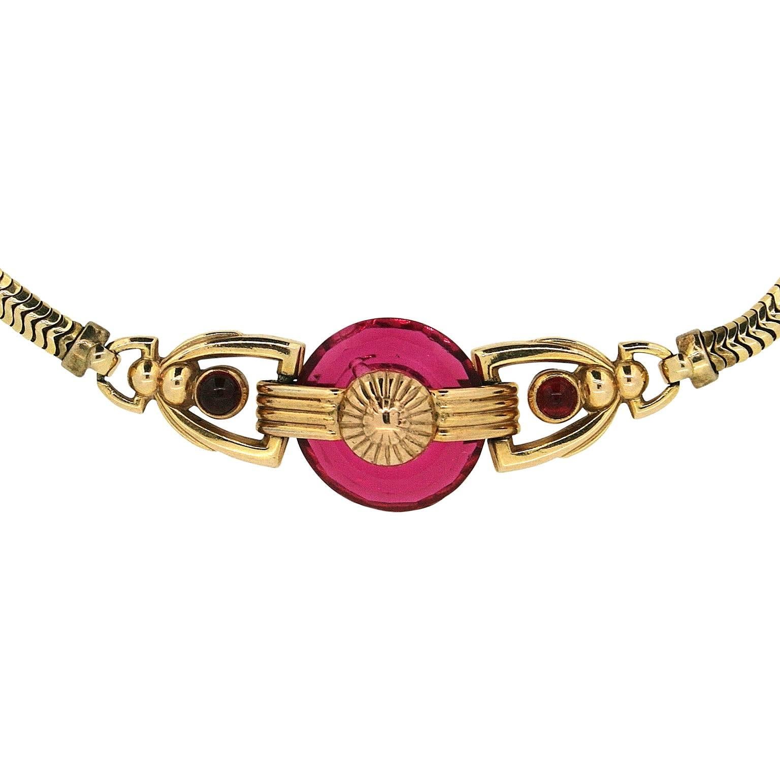 A pretty and versatile example of jewellery by the American Kreisler company. 
Condition Report:
Excellent
The Details...
This bracelet features a snake chain and is detailed with a central, geometric style design incorporating red glass cabochons
