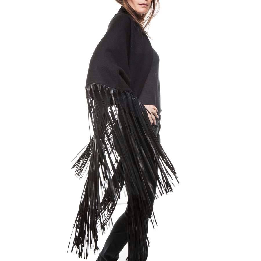 Very researched. Hermes shawl in black cashmere and black wool with lamb leather fringes. 
Vintage accessory in very good used condition (some pilling)
Great classic. 
Dimensions: length 220 cm, height from top to bottom to the point 110 cm, length