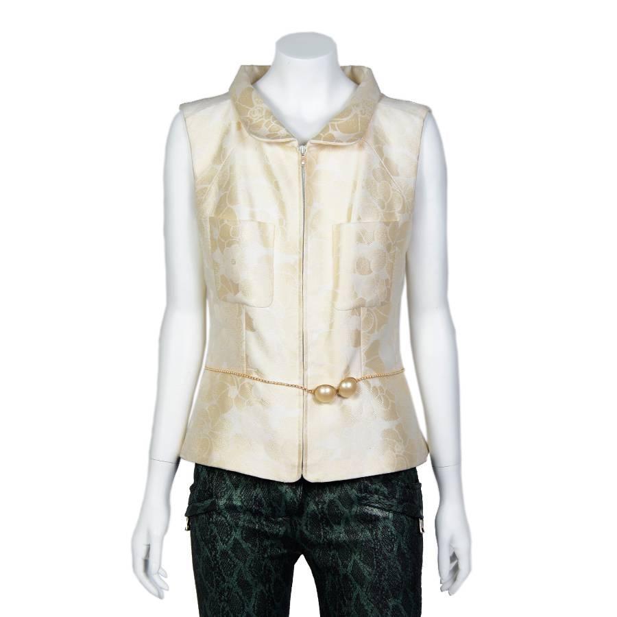 Very stylish !! Chanel cotton sleeveless Jacket with a beaded pearl belt. Size 42FR. 
Spring 2001 Collection.
Two patch pockets at the front. Zipped closure. The lining is in off-white silk with camellia prints.
Condition : Very Good. Little