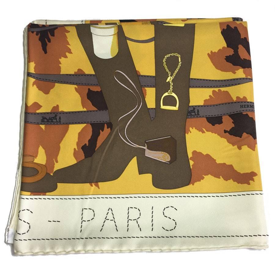 Hermès 'Monsieur, Madame' scarf in silk. Color : ivoire bordure and curry, brown and khaki background. 
Design: the symbols of the brand: leather goods, perfumes, bags.
S buffered letter of Private Sales

Designed by: Bali Barret

Delivered in a