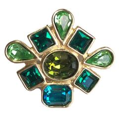 YVES SAINT LAURENT brooch pins in gilded metal and green stones
