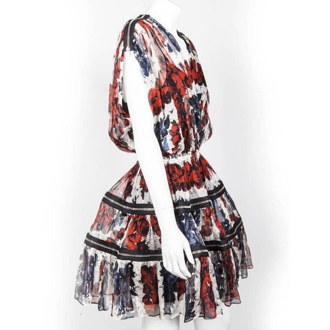 Jean Paul Gaultier dress in chiffon printed with roses in the colors of the country. This creation with the rock accents is embellished of multiple zip on the petticoat and the shoulders. 
You can wear it with or without its black lining. An iconic
