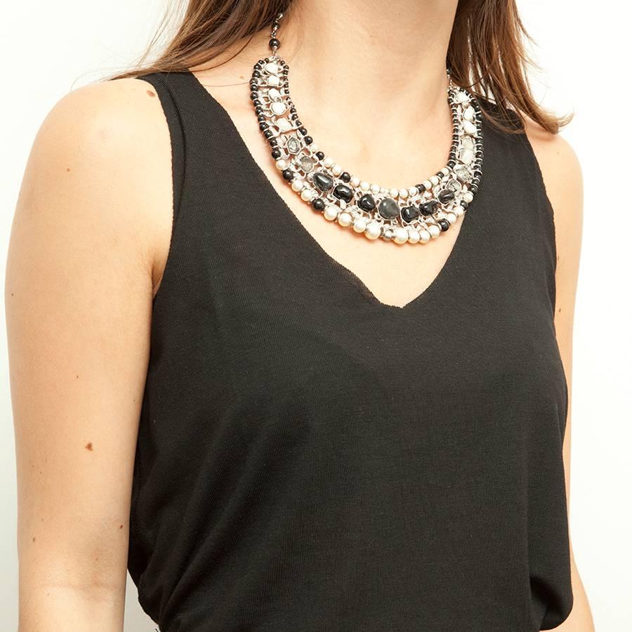 Chanel Crew Necklace. It has 3 rows of nacreous and black glass pearls, iridescent gray and black cabochons and rhinestone with palladium silver metal plated jewelery. 

Ideal for an evening.

Dimensions: choker to the last ring 48 cm, height on the