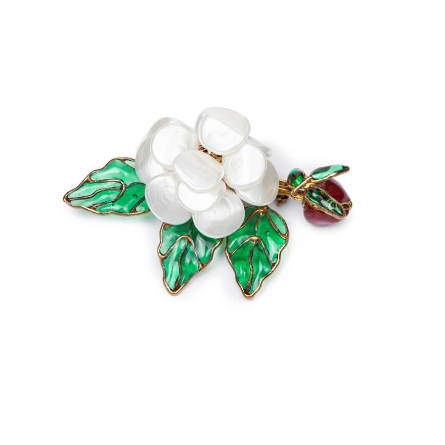 Vintage! Magnificent Chanel pendant camellia Brooch in pearly molten glass set up on gilt metal. In the shape of flowery branch, the camellia is in pearly molten glass, the bud is also in molten glass ruby and leaves emerald. 

Not signed dating the