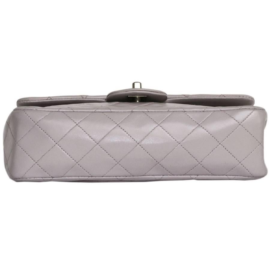 Chanel 'Timeless' double flap bag in Parme color lamb leather.  Clasp 'CC'. Silver plated metal hardware. Double flap. 

Hologram: 5273 .... no authenticity card. 
The interior is darker purple lamb leather with 3 patch pockets. 
Dimensions : 