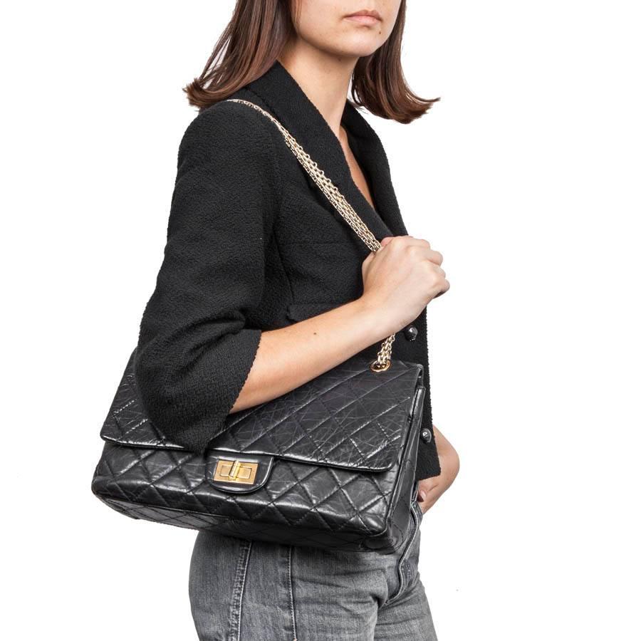 Chanel 2.55 double flap bag in black quilted aged lamb leather. It has a golden aged hardware.
Worn shoulder or crossover with the handle in chain: 124 cm. 

It has an outer slot and a double flap with a zipped pocket in the first flap as well as a