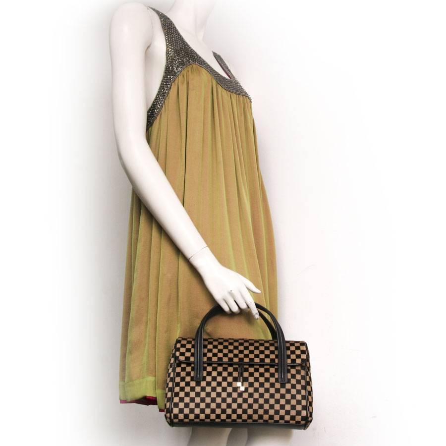 Very nice Louis Vuitton 'Damier sauvage' handbag limited edition in calf hair.

The finishes, handles and bottom of the bag are in a smooth, rare and high-quality brown calf leather. The inside of the bag is in brick color Alcantara and has a small