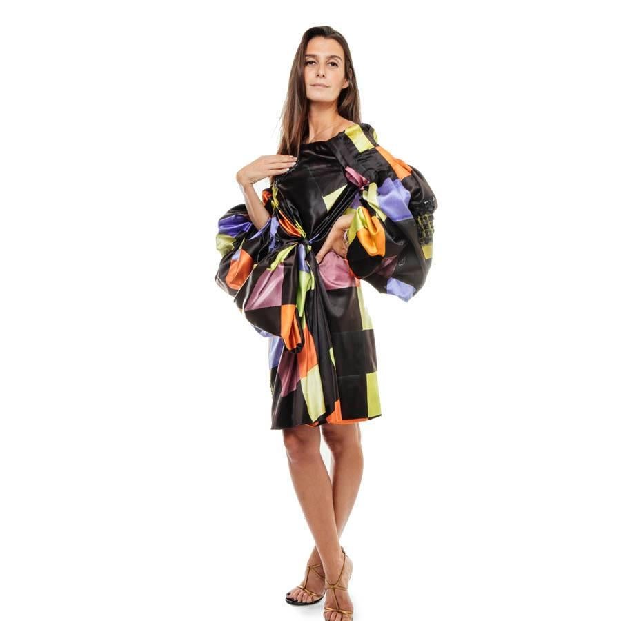 Spectacular Christian Lacroix couture dress with multicolored printed patterns with lace patches and black sequins. It is made of cotton and silk. 
The dress is reinforced by a bustier. The lining is in silk and cotton. The sleeves are 3/4 very