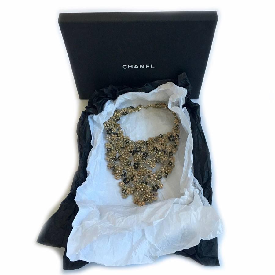 Just wonderful!! Haute couture piece for collectors.

Chanel bib necklace handmade flowers in molten glass. Represents more than 40 hours of work. In gilded metal and pastel shades and sequined molten glass. Some florets are embellished with pearly