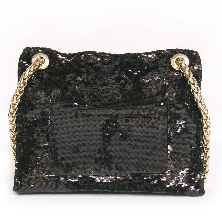 Stunning Balmain 'Ultimate' flap bag entirely embroidered with black sequins, outside pocket applied to the back of the bag. The sides, the underside of the bag and the inside of the flap are in black velvet calfskin. 
Two compartments inside black