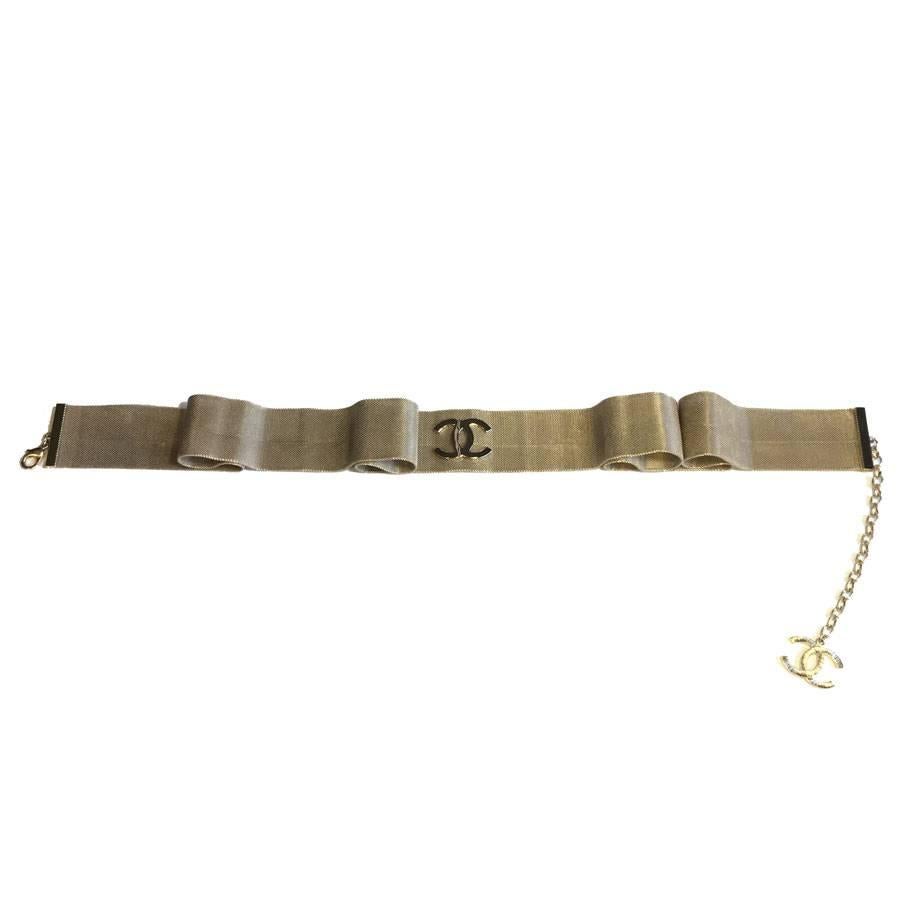 Chanel belt in pale gold gilded filigree, CC in the center in gilded metal. It comes from the collection of 'Paris-Cosmopolite Arts & Metiers' 2016-2017.

Dimensions: total length (belt + chain): 105.5 cm, at the shortest: 92.5 cm, at the