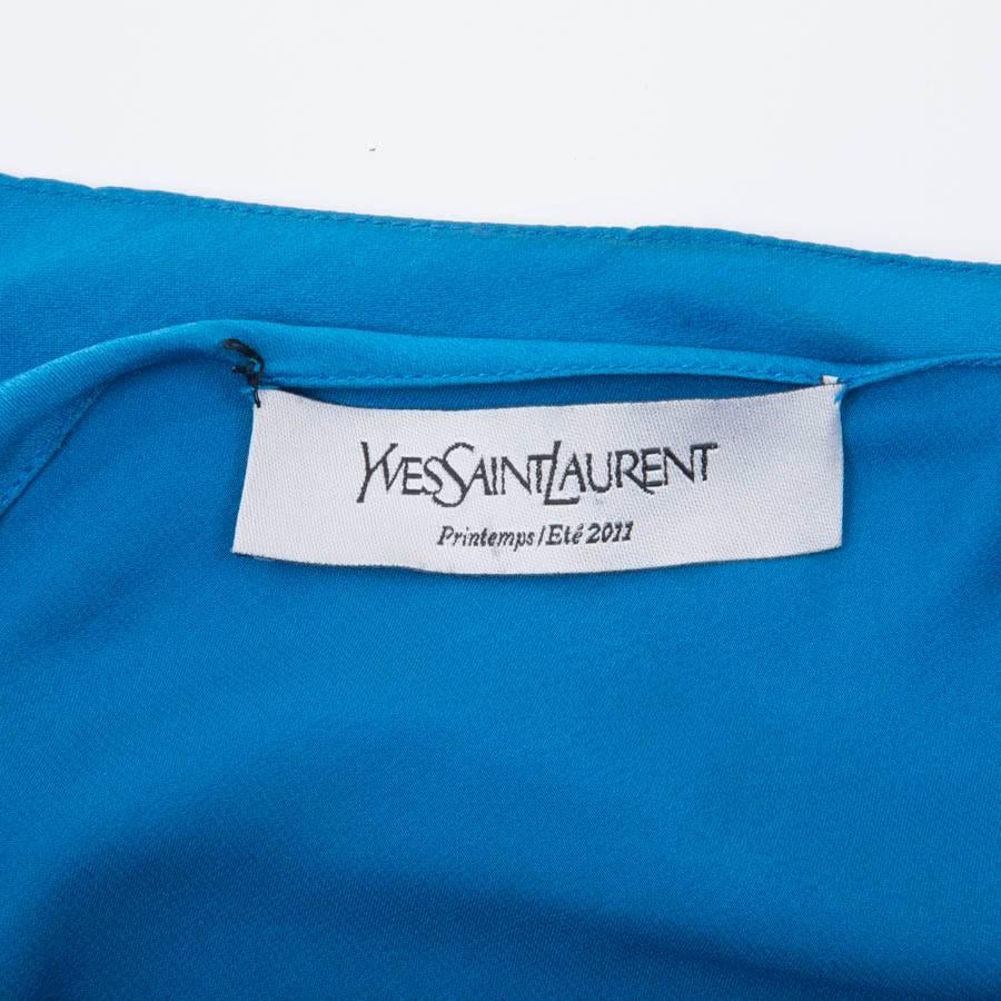Yves Saint Laurent blouse in royal blue silk cut at an angle.

Spring / Summer 2011 collection. 

Dimensions flat:  width 53 cm, sleeve length 73 cm, shoulder width 36 cm