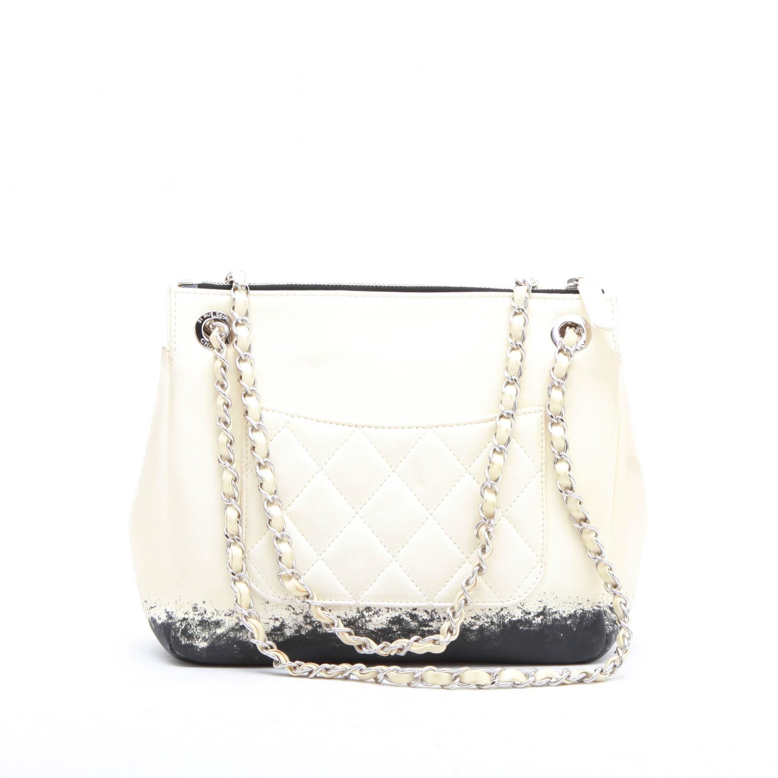 Chanel bag in beige and black two-tone lamb leather. Silver palladium hardware. Zip closure. The interior is in black satin. 
Included : Hologram 14088... year 2011. No authenticity card. 
Stamp S from the private sales at the bottom of the bag.