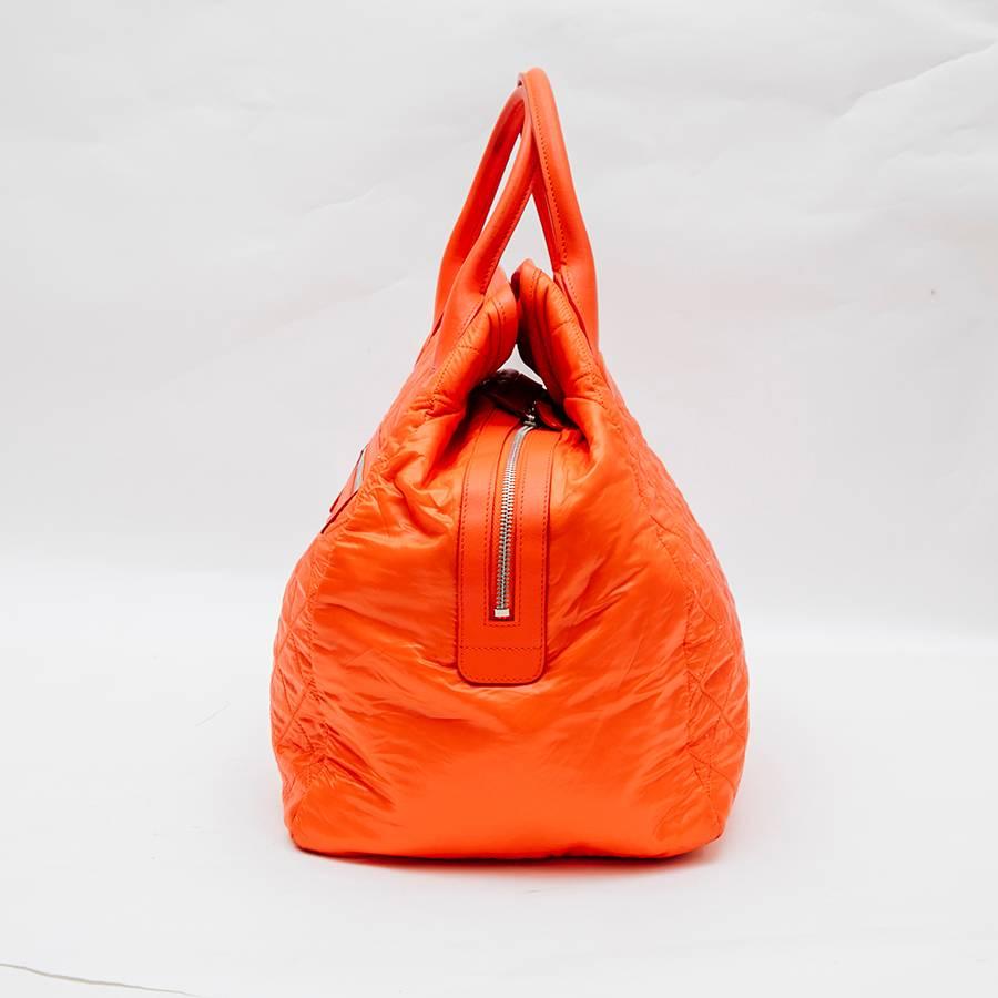 Chanel 'Cocoon'  bag in orange waterproof material. This bag is coming from runway without hologram or card.

Spring 2014. 'Supermarché' collection.

Silver metal hardware.  Zip closure. Made in Italy. 

Length 48 cm, height 32 cm, depth 20