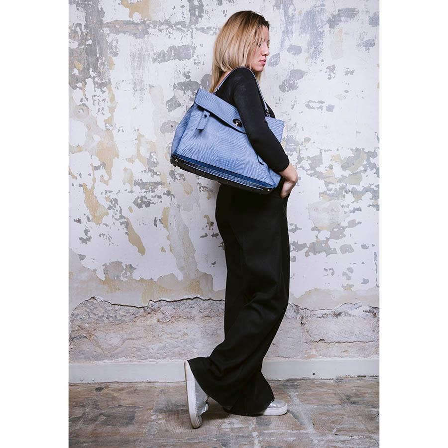 Yves Saint Laurent Muse II bag in blue python effect leather. The hardware is in silver palladium metal. There are three compartments and a large outside pocket with 3 buttons.
Worn by hand. Blue suede interior. In a perfect condition.

Serial