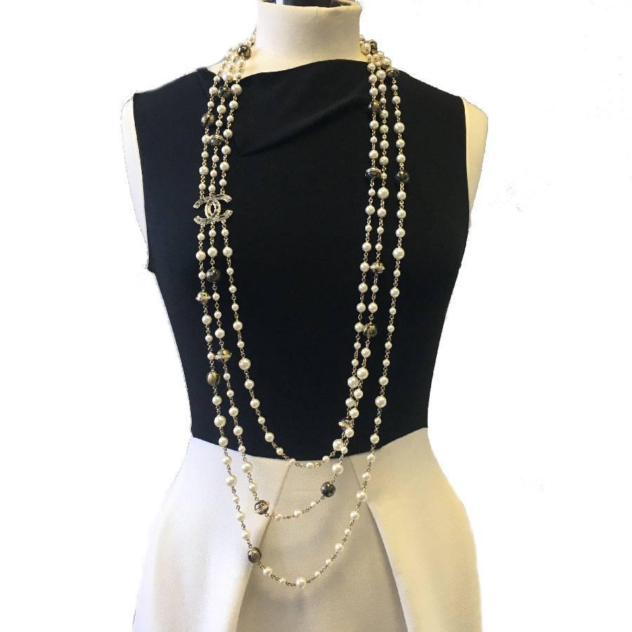 Beautiful Chanel necklace triple rows pearl beads and gold and black balls, a golden CC connects the 3 rows of pearls.

In excellent condition. Spring-summer 2013 collection.

Dimensions: total length reach 101 cm

Will be delivered in its box Chanel
