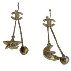 CHANEL Star and Moon Pendant Stud Earrings in Gilt Metal and Glittered Resin