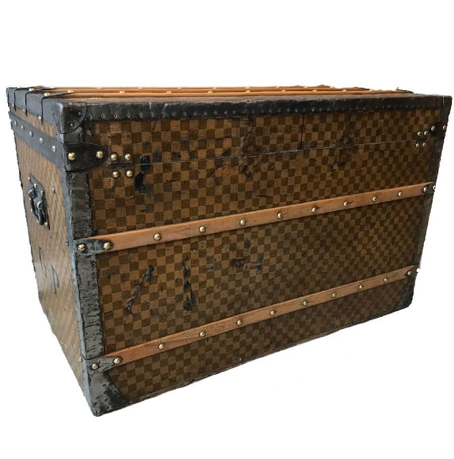 Vintage Louis Vuitton trunk in checkered canvas dating from the Universal Exhibition, most likely made in the 18th century. The damier canvas is the first painting created by Louis Vuitton, before the legendary LV.

State of origin (see
