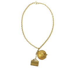 Retro CHANEL Long Necklace in Gilt Metal with Bag and Hat Pendant