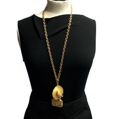CHANEL Long Necklace in Gilt Metal with Bag and Hat Pendant
