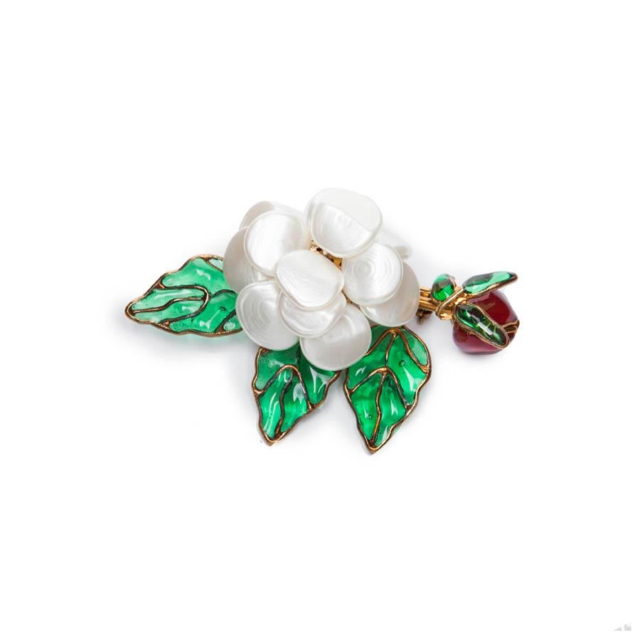 Beautiful Chanel vintage Couture camellia pendant brooch made in molten glass and mother-of-pearl mounted on gold-plated metal. Flower-shaped branch, the camellia is pearly molten glass. The bud is also in ruby molten glass and emerald leaves.