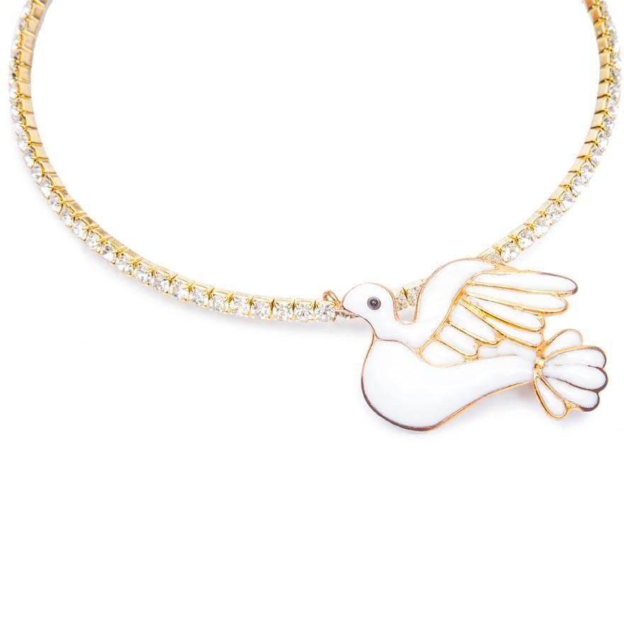 Vintage. Loulou de La Falaise choker necklace in golden metal set all around with Swarovski brilliants. It was manufactured at the time by the House Gripoix. The pendant represents a dove made of white molten glass. 

Size: short neck 35 cm, longer