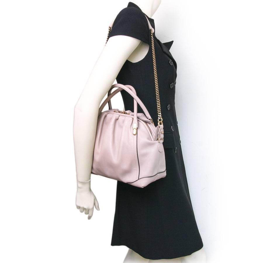 Nina Ricci 'La Rue' Bag in powder pink lambskin leather. Matte gold hardware.
Excellent condition. Long shoulder strap.

Worn by hand with two handles and on shoulder.

Collection of Peter Copping which was inspired by the doctor bag. It is elegant