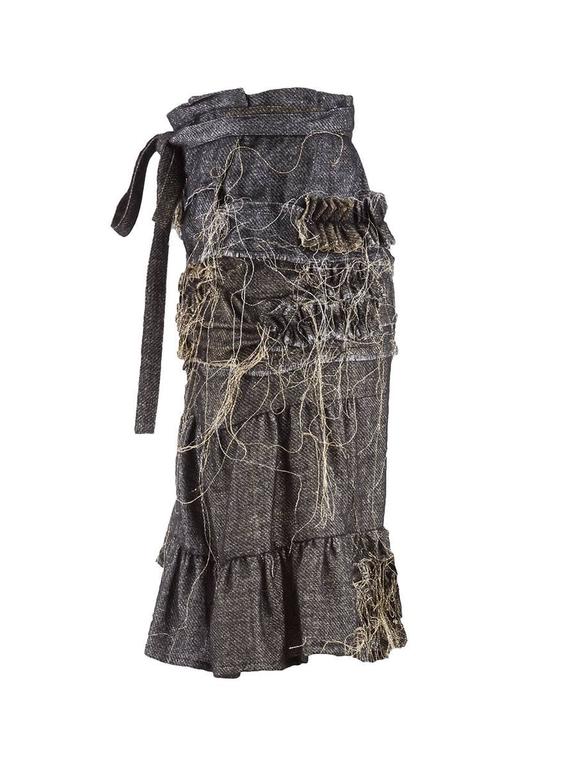 Tao Comme des Garcons metallic denim asymmetric wrap skirt featuring sparkly gold and silver stitching throughout with unfinished seams and dangling thread. Has an asymmetrical ruffled hem and a wrap style tie closure at the waist.