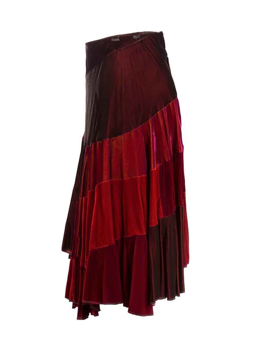 1990's Comme des Garçons asymmetric mid length comprised of shades of deep red velvet. Draped front and side panel and a back zipper closure.