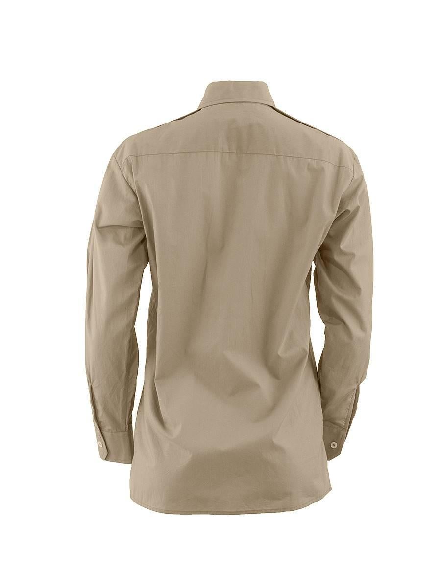 Beige military style button up long sleeve shirt with pointed collar, epaulettes, covered buttons and front pockets from the MAISON MARTIN MARGIELA Artisanal Collection. 20th Century. New with Tags.
