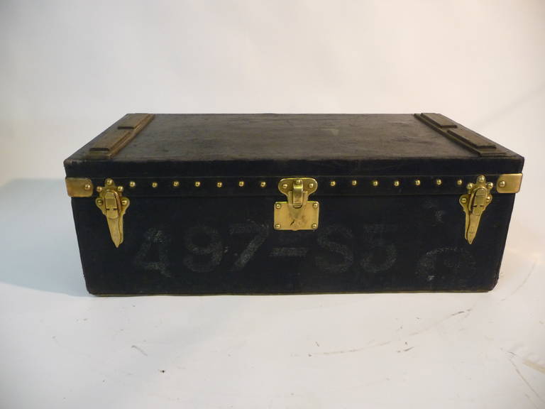 Beautiful dark blue car trunk Louis Vuitton Black /, coated canvas 

Wood Lath reinforcements on top 
Clasps, lock and solid brass nails 

On the side of the trunk a brass plate is a name 

On the front, a number of former imatriculation the