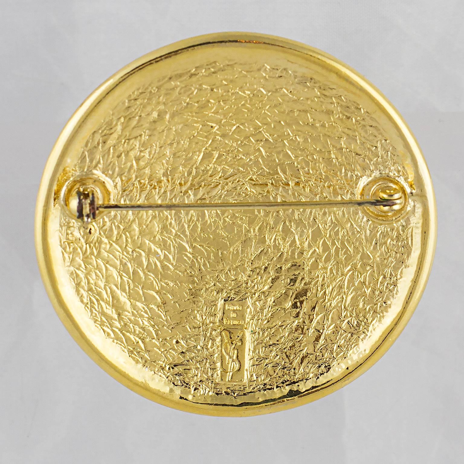 Yves Saint Laurent round brooch featuring Aztec inspired detail.
High carat gold plated metal.
Made in France in the 1980's