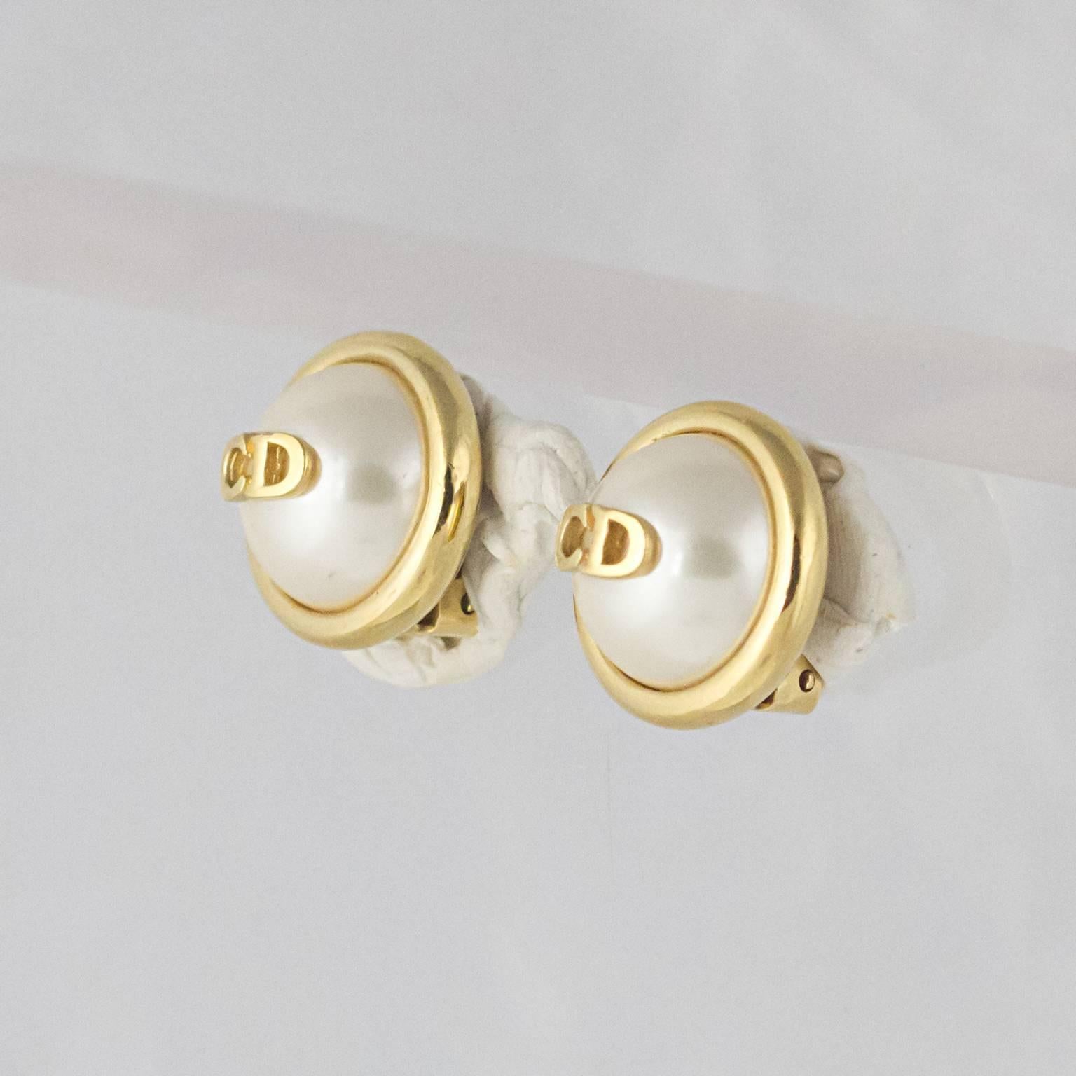 A Pair of Christian Dior 'CD' Faux Pearl Clip-On Earrings. Very Chic!
Made from high carat gold plated metal on faux pearl with comfortable, safe ear clips.
In an excellent vintage condition.