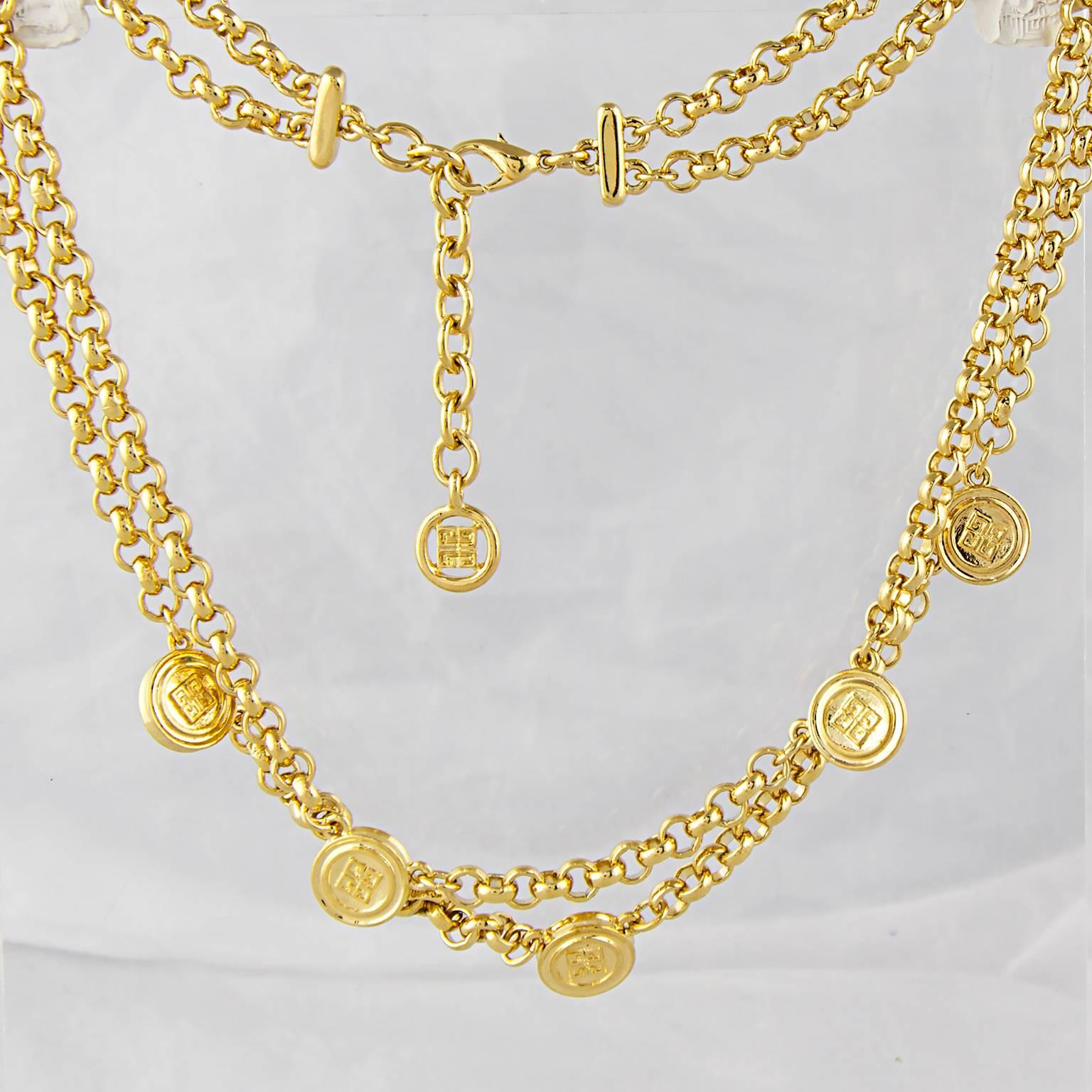 A high carat gold plate Givenchy double chain necklace with logo charms.
Made in the 1990's.
Fully signed. 
In a perfect condition. 
Don't hesitate to contact us with any queries or image requests.