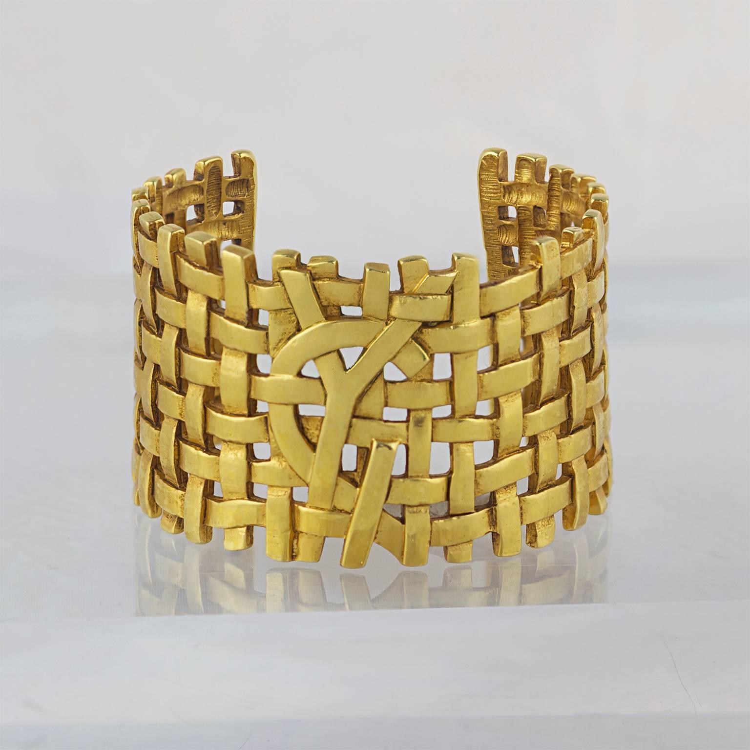 A highly sought after cuff by Yves Saint Laurent with 'hidden' YSL logo, in high carat gold plated metal.
Made in the 1980's.
Fully signed. 
In a great pre-loved condition. 
Don't hesitate to contact us with any queries or image requests.