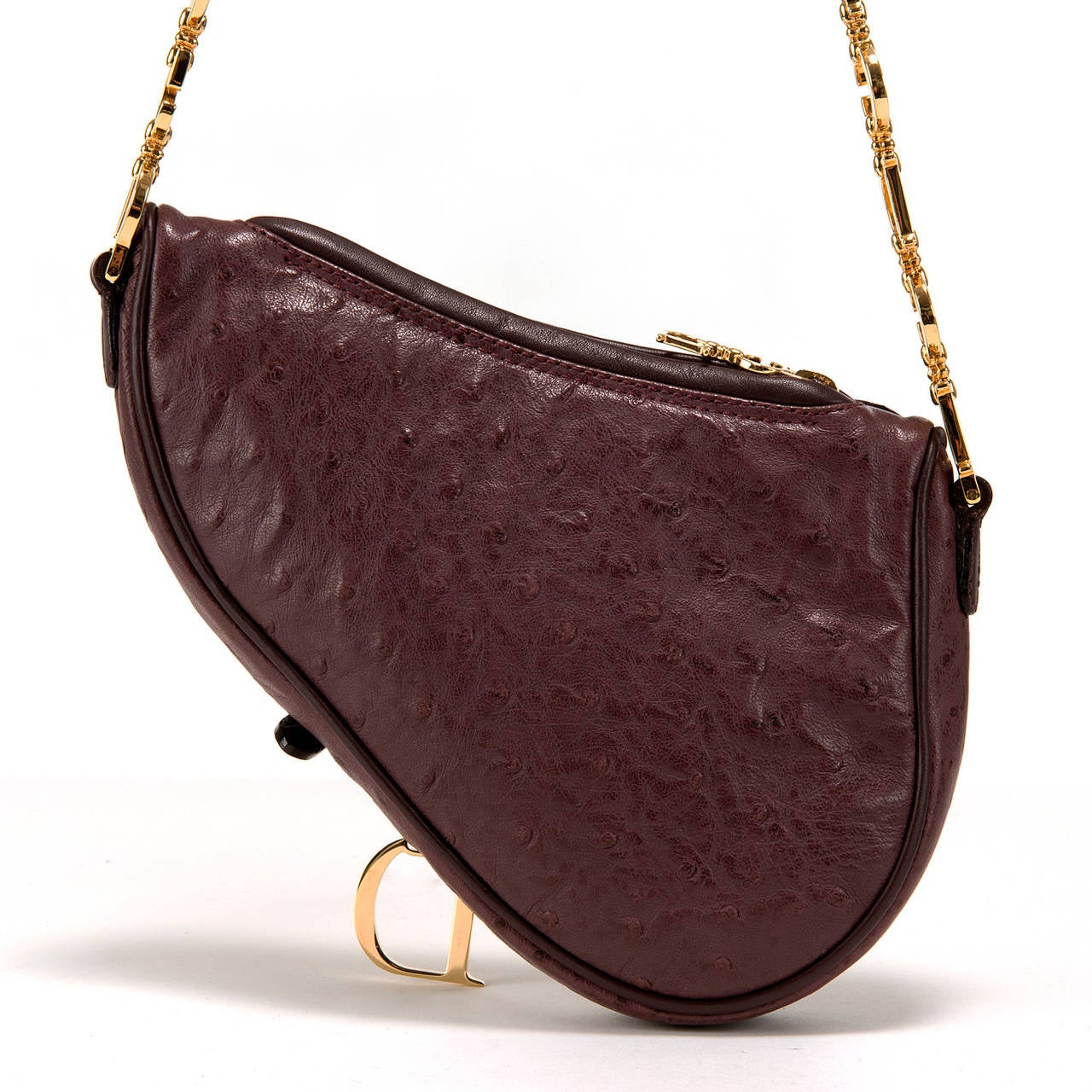 An Absolutely stunning, top of the range, Handbag by Christian Dior. Finished in exotic Ostrich-skin with a beautifully crafted Gold-tone 'C.D.' logo handle, the combination of the Aubergine coloured Ostrich-skin with the bold gold-tone logo-handle,