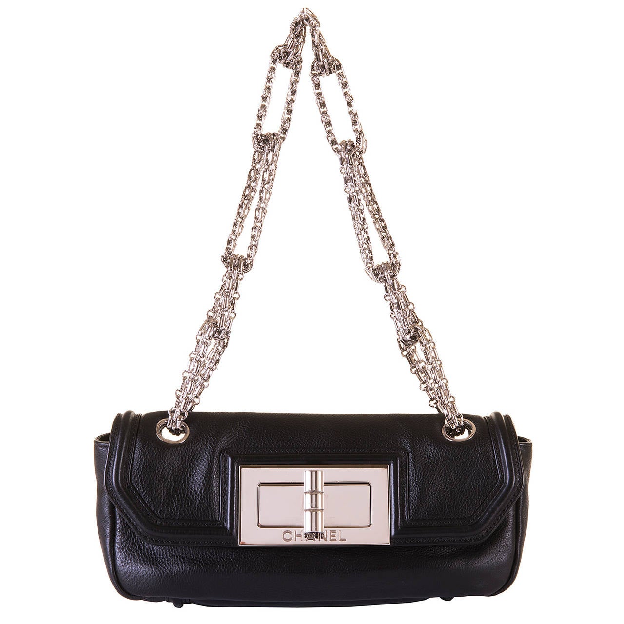 This fabulous Chanel Bag, made in circa 2012, is in perfect condition and is finished in black grained lambskin with silver palladium hard wear. The flap-bag, with it's pivot-turn, oversized, signed silver clasp, is beautifully complemented with