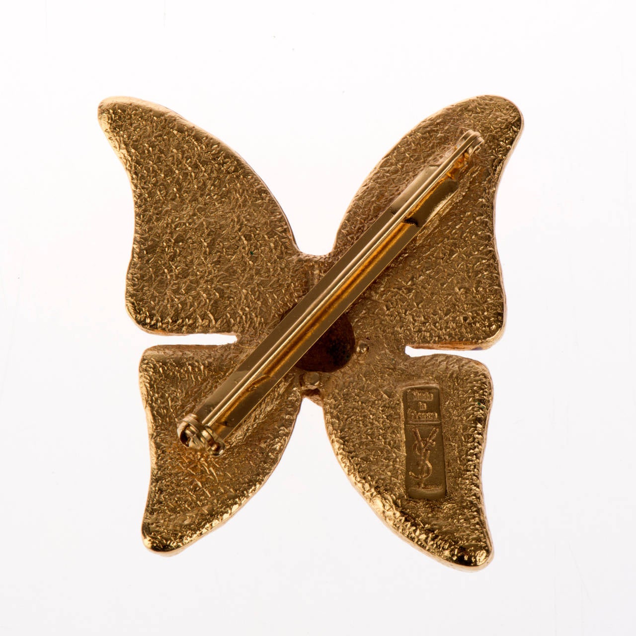 A delightful gilt and enamel 'Butterfly' brooch by Yves Saint Laurent.The Aubergine enamel is almost translucent and together with the textured gilt, makes this brooch a real treasure from this famous Paris Designer.