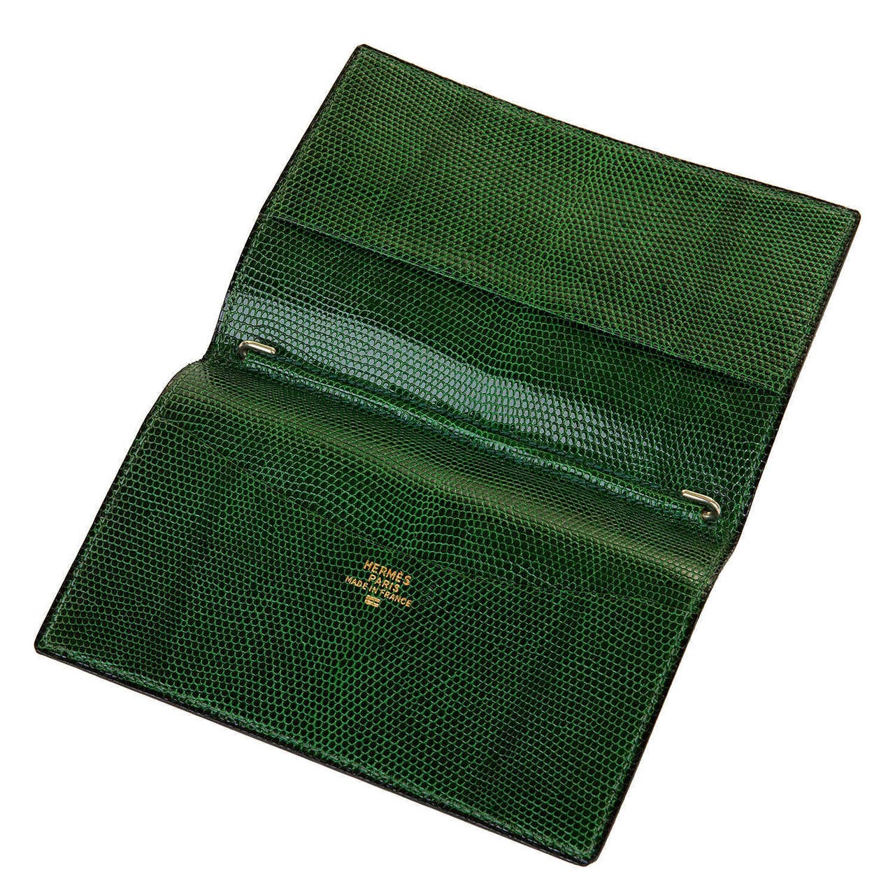 This Hermes 'Porte Agenda' - note book cover, in Green Lizard, is in 'New' condition and is a perfect accessory for most handbags & clutches. Bearing the Hermes signature stamp, in gold-leaf, to the interior, it is a charming Hermes piece.

FREE