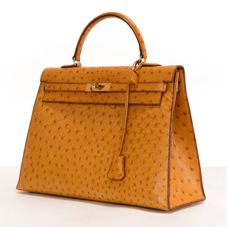 A truly Iconic bag. This fabulous, elegant Kelly bag, finished in saffron coloured Ostrich, is in pristine condition and comes with it's original Hermes dust sac, padlock, keys and shoulder strap. With goldtone fittings the bag is impressed with the