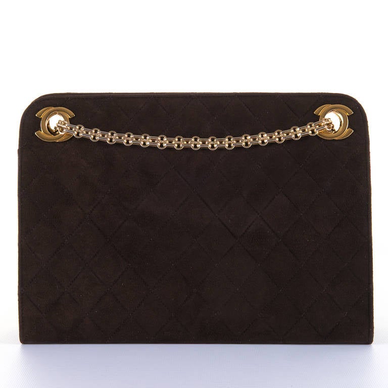 A fabulous Chanel lambskin quilted suede Handbag in Chocolate Brown, finished with a double chain link handle with Iconic 'Double C' Gilt-metal Hardware. The bag with the interior in matching chocolate brown leather, measures 10.5in (26.5cm) wide x