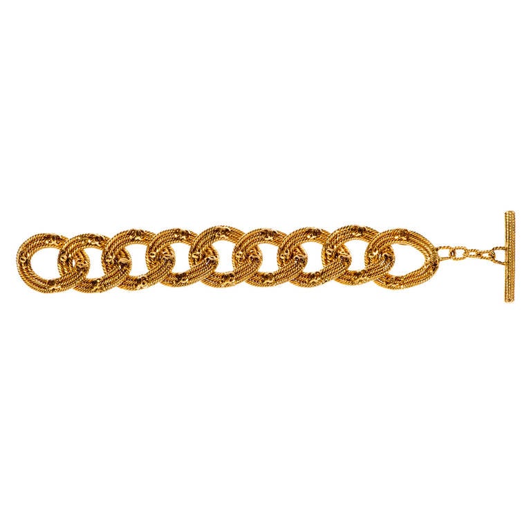 If you love Chanel, you will adore this beautiful, iconic  double 'C' Bracelet. Each oval shaped link has been expertly made from three coils of rope twist gold-metal, surmounted with 4 double 'C' motives, with a simple T-bar clasp. Signed 'Chanel -