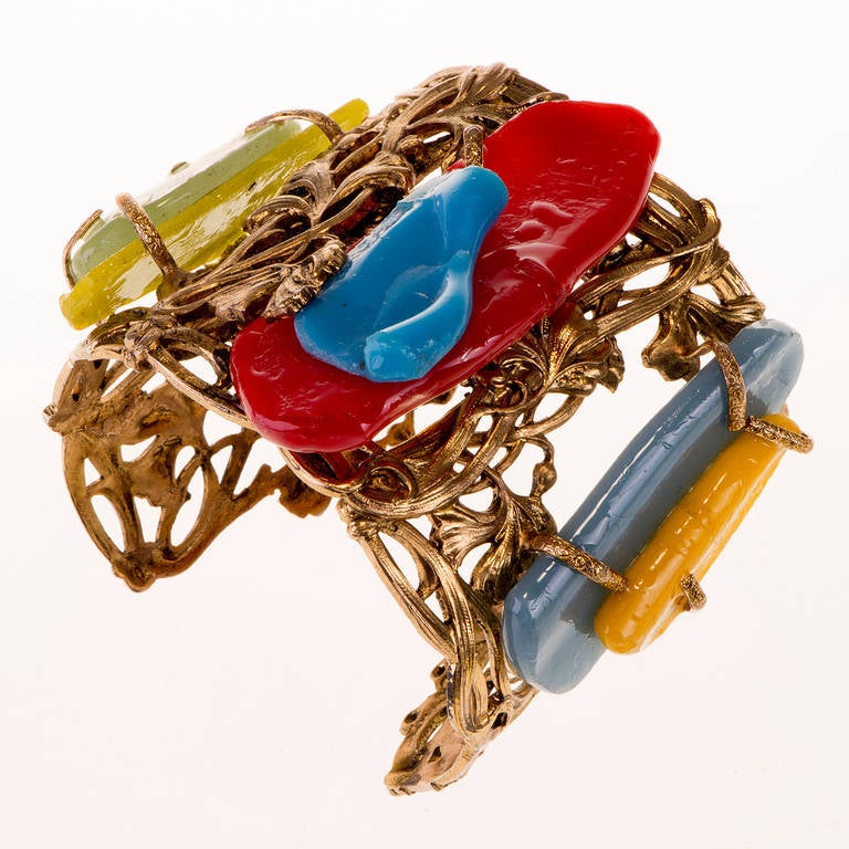 This unique 'Haute Couture' vintage piece by Nina Ricci, in excellent condition, is very unusual, with it's intricate metalwork, very much in the Art Nouveau taste, the Cuff has been then decorated with abstract multi-coloured resin stones. A very