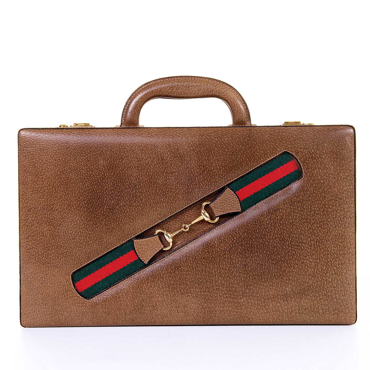 A fabulous cased 'Backgammon' set by the famous House of Gucci.The outside is finished in a grained light brown leather, with a signature Gucci faux-belt in red & green to the front, with gold tone hardware. The inside is finished with inlaid